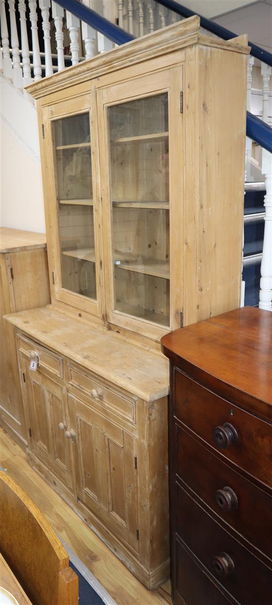 A Victorian glazed pine bookcase / cupboard W.115cm